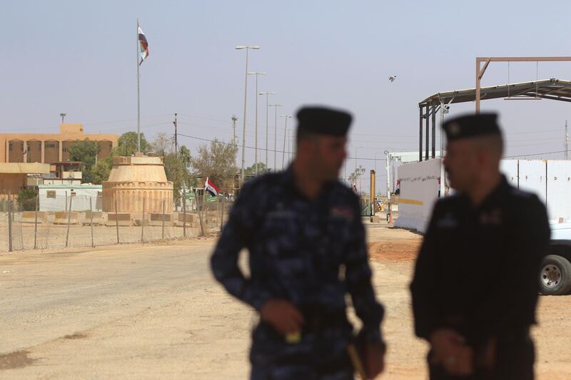 TREIBIL, IRAQ BORDER - AUGUST 30: Iraqi officers stand at the crossing gate after Jordanian and Iraqi senior officials attend a special ceremony to mark the reopening of the Treibil - Karamah border on August 30, 2017 in Treibil, Iraq border. The border, which is the only land border crossing between Iraq and Jordan, was closed in 2015 when large areas in north and west Iraq, including Anbar border province, fell to Islamic State extremist group Daesh. (Photo by Salah Malkawi/ Getty Images)