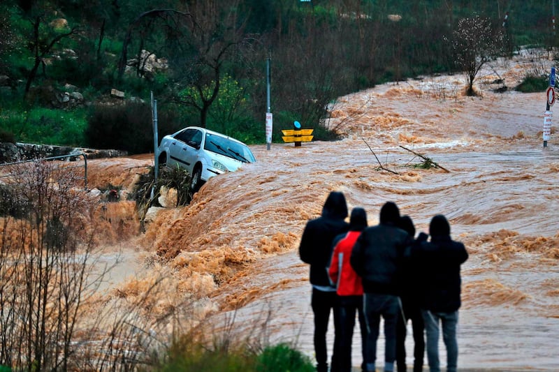 Flash floods caused by torrential rain go down a street on the outskirts of Jerusalem. AFP