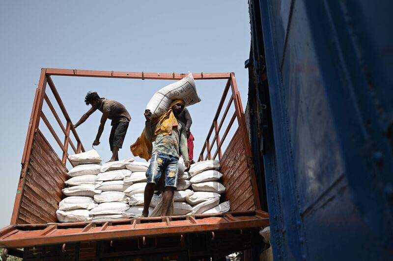 Workers load sacks of wheat on a freight train in Khanna, Punjab state. India, the world's second-largest producer of wheat, has banned exports without special authorisation from the government. AFP