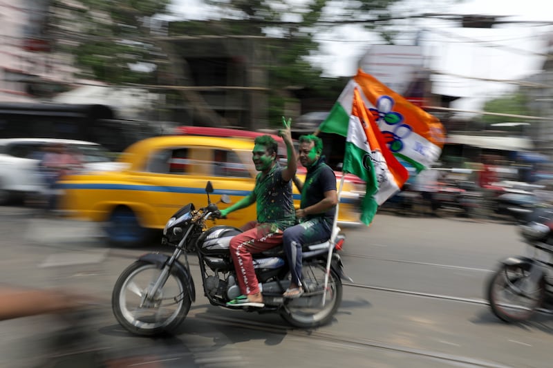 Trinamool Congress Party supporters celebrate their party's election results in Kolkata on Tuesday. EPA