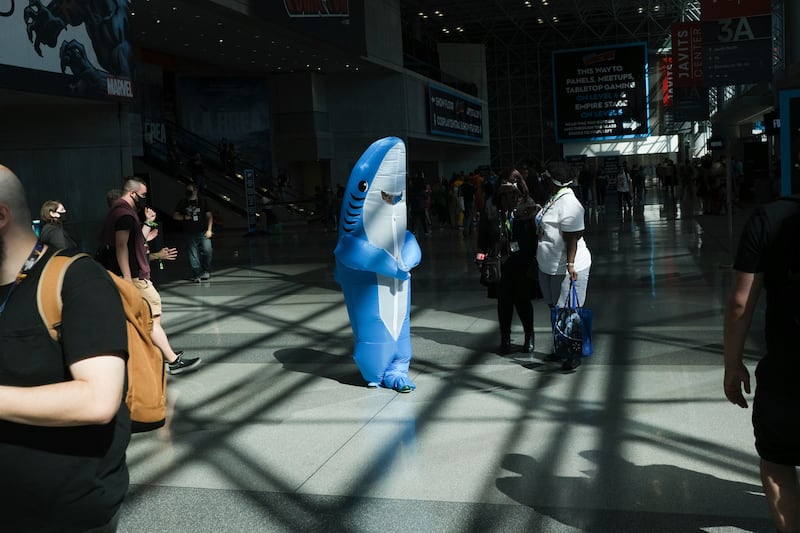 A person in a shark costume walks though New York Comic Con. Seth Wenig / AP Photo