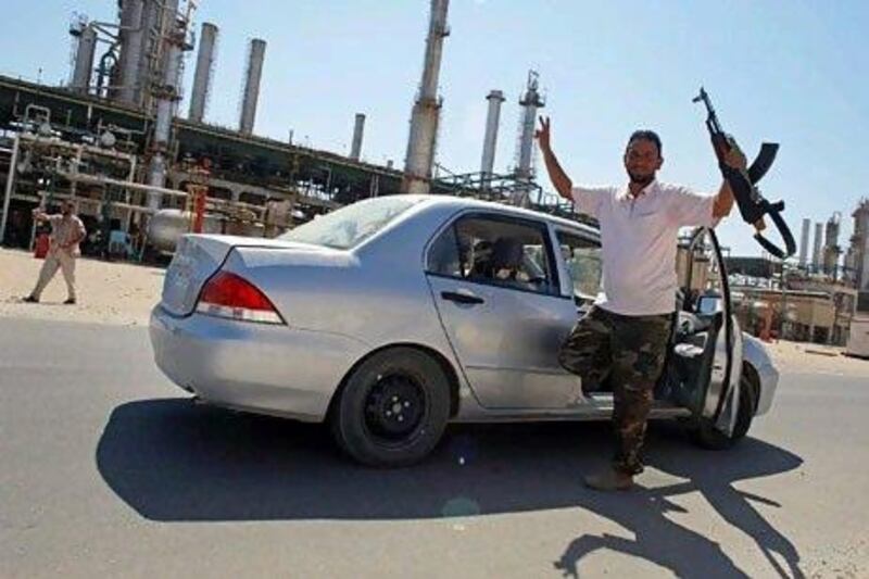 Rebel fighters celebrate after taking full control of the Zawiyah oil refinery. Reuters