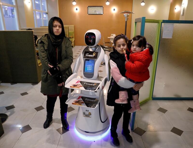 Afghan girls pose for a photo with Timea at the Times Fast Food restaurant. Reuters