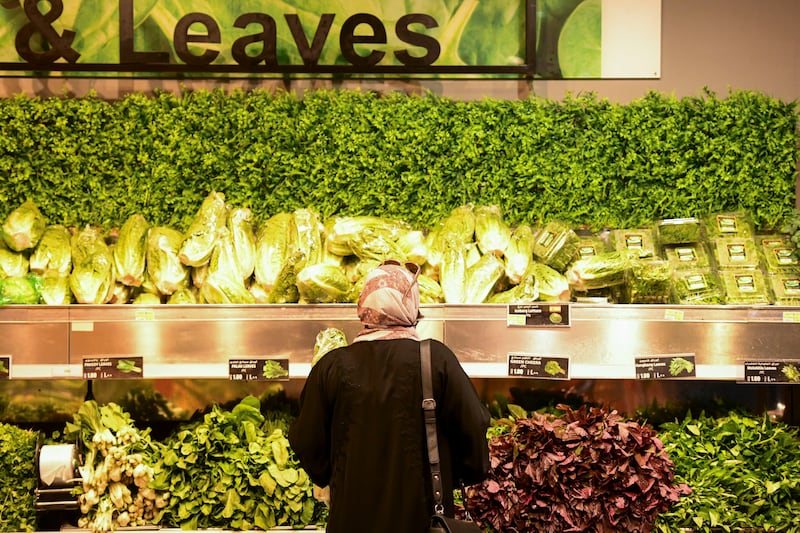 A shopper buys vegetables at Lulu Hypermarket in Abu Dhabi. Khushnum Bhandari / The National