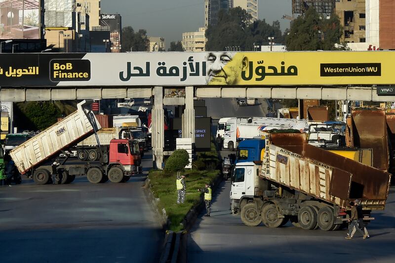 Demonstrators block the road with lorries during a protest against increased costs, petrol prices and deteriorating living conditions, in the Dora area of northern Beirut.  EPA