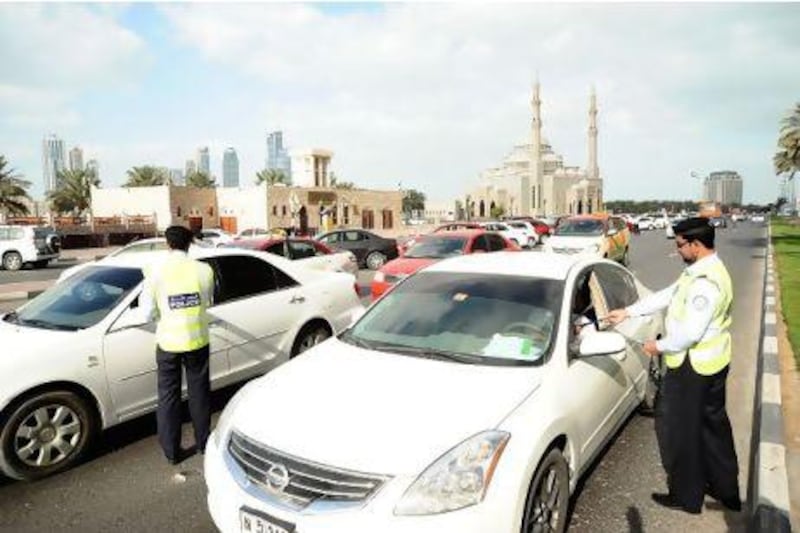 Sharjah police distribute brochures to motorists reminding them not to leave their cars unattended with the key in the ignition. Courtesy Sharjah Police