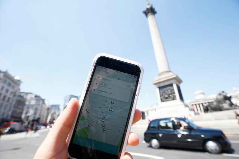 A photo illustration shows the Uber app and a black cab in London, Britain, June 25, 2018. REUTERS/Henry Nicholls/Illustration