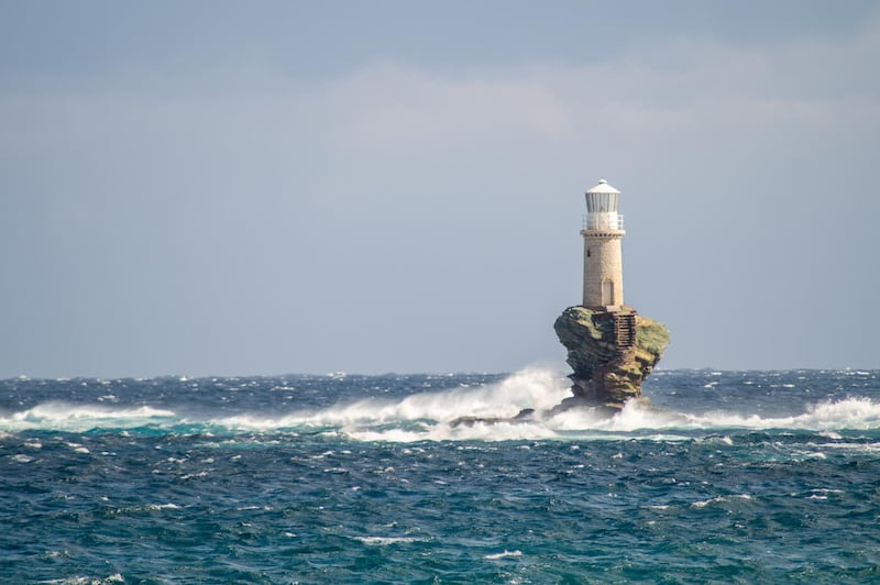 A lighthouse off the coast of Andros. Vasileia Eleftheriou / Unsplash