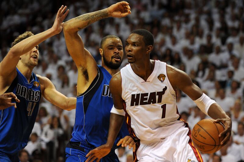 Chris Bosh, right, is crowded by Tyson Chandler, centre, and Dirk Nowitzki, left, during Game 1 of the NBA Finals.