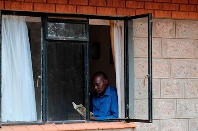A man reads a book to pass the time at a Government designated quarantine facility in Nairobi on April 04, 2020.  Hundreds of people held under mandatory quarantine in Kenya after returning from abroad are up in arms after the government extended their confinement for another 14 days.
Around 2,000 people were placed in forced quarantine as they arrived in the country from March 22 until international flights were banned three days later, a chaotic process criticised by some passengers as likely to have helped spread the virus.
Health ministry guidelines initially said that those quarantined would be tested after five days and if their results were negative they would be sent home to self-isolate. Those testing positive would be taken to treatment centres.
An unknown number were discharged. However the rest who had hoped for freedom after their two weeks were up were stunned when the government on April 4, 2020, ordered a 14 day extension of quarantine for those in facilities which had registered a positive case. / AFP / -
