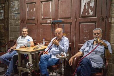 Nour Kassar, right, 60, smokes shisha with friends 