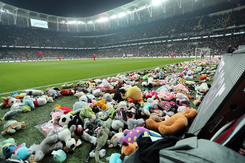 Toys at side of the pitch thrown by fans for children affected by earthquake during a Turkish Super League match between Besiktas and Antalyaspor. AFP