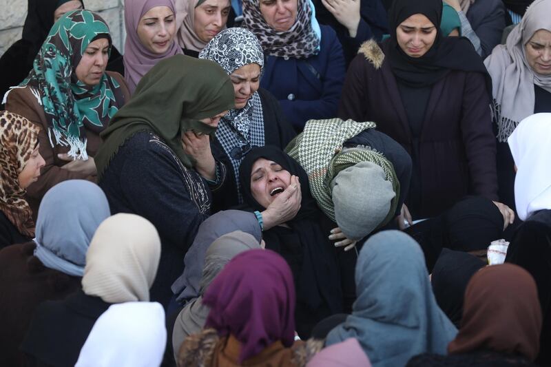 Palestinian relatives  of Yazan Abu Tabekh, 19, weep during his funeral in the west bank city of  Jenin. Abu Tabekh and other Palestinian policeman  were shot killed by Israeli forces after Israeli forces demolished a Palestinian house in the Jenin. Seven other Palestinians were  wounded during the clashes.  EPA