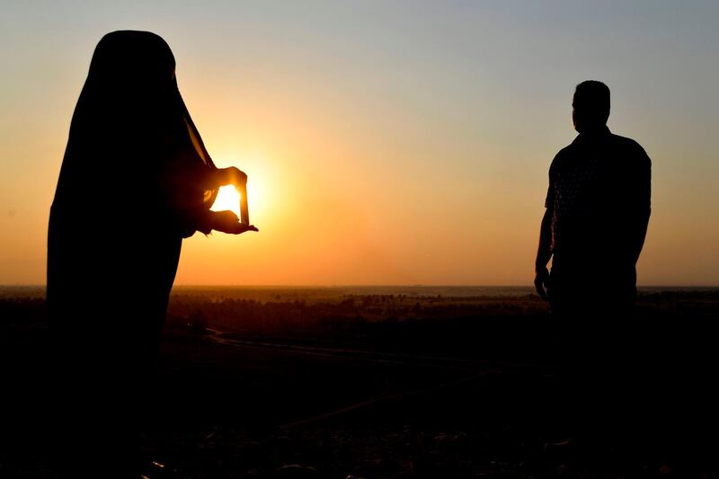 Iraqis take pictures close to the Nabu temple at the Borsippa archeological site near Hillah in the Iraqi province of Babylon.  AFP