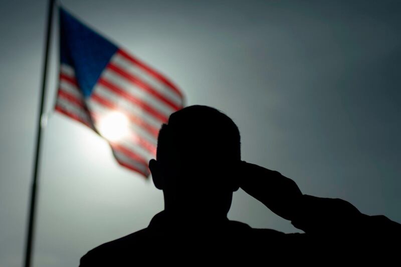 A US Air Force sergeant salutes the flag at Camp Simba in August 2019. AFP