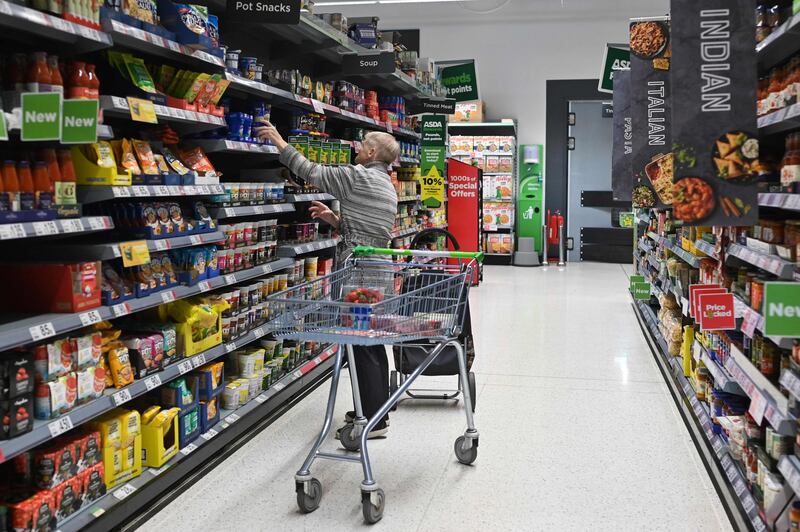 Shopping at an Asda supermarket, in Aylesbury, Buckinghamshire. Britain's annual inflation rate dropped sharply in July to below seven per cent, off the back of lower energy prices and in line with economists' expectations. AFP
