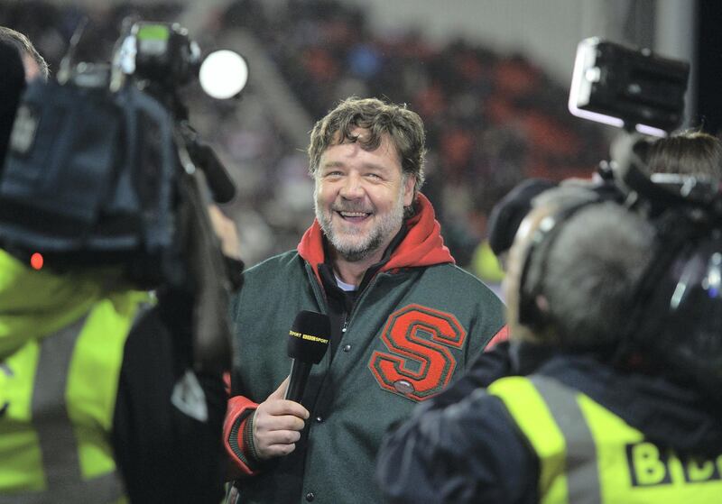 ST HELENS, ENGLAND - FEBRUARY 22:  Actor and co-owner of South Sydney Rabbitohs Russell Crowe is interviewed by the BBC prior to the World Club Challenge match between St Helens and South Sydney Rabbitohs at Langtree Park on February 22, 2015 in St Helens, England. The match is the climax of the newly-expanded World Club Series.  (Photo by Gareth Copley/Getty Images)