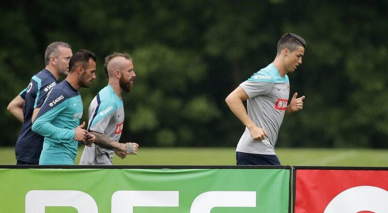 Cristiano Ronaldo of Portugal leads a run with teammates Beto, second left and Raul Meireles, second right as the national team train at the NFL facilities of the New York Jets ahead of the 2014 World Cup in Brazil. Ray STubblebine / Reuters / June 3, 2014