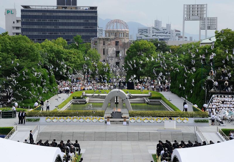 Doves fly in front of the Atomic Bomb Dome at the Peace Memorial Park after being released during the memorial service to remember the 1945 atomic bombing of Hiroshima on August 6, 2011. Japan marks the 66th anniversary of US atomic bombing of Hiroshima as the country struggles to end a crisis at a nuclear power plant ravaged by the March quake-tsunami disaster.  AFP PHOTO / TORU YAMANAKA
 *** Local Caption ***  560283-01-08.jpg