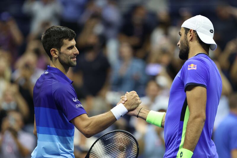 Novak Djokovic of Serbia shakes hands with Matteo Berrettini of Italy after winning their US Open quarter-final match. AFP
