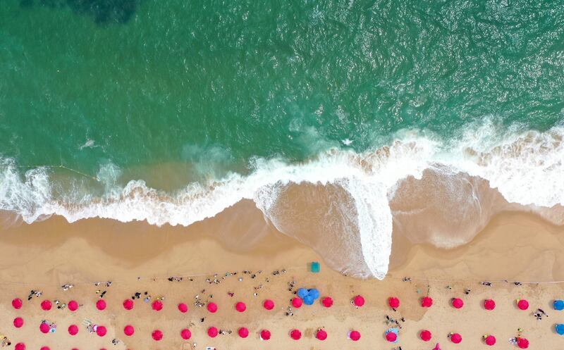 An aerial view of visitors staying out of the water at Sokcho Beach in Sokcho, South Korea,  after swimming was banned due to strong waves. EPA