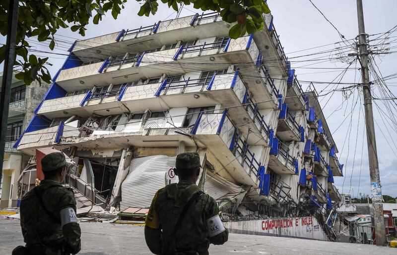 Soldiers stand guard a few metres away from the Sensacion hotel which collapsed with the powerful earthquake that struck Mexico overnight, in Matias Romero, Oaxaca State. AFP