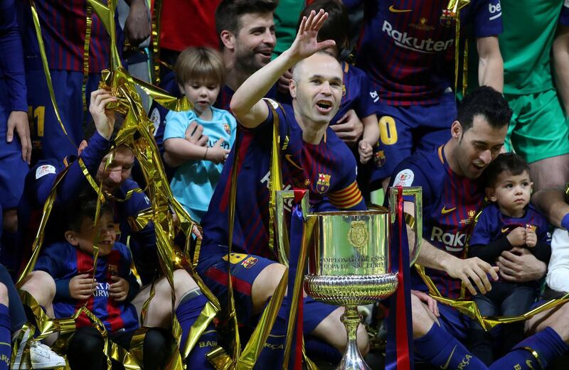 FILE PHOTO: Soccer Football - Spanish King's Cup Final - FC Barcelona v Sevilla - Wanda Metropolitano, Madrid, Spain - April 21, 2018   Barcelona's Andres Iniesta, Lionel Messi, Gerard Pique and Sergio Busquets celebrate with the trophy after winning the final   REUTERS/Susana Vera/File Photo