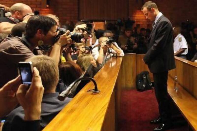 Oscar Pistorius stands in the dock during his bail hearing at the magistrate court in Pretoria. Themba Hadebe / AP Photo