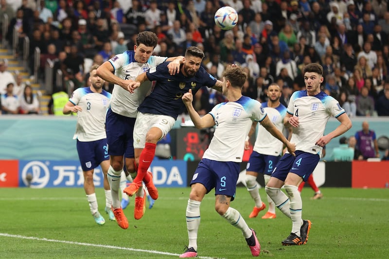 Giroud leaps with England defender Harry Maguire. AFP