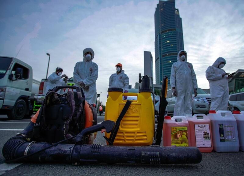 Abu Dhabi, United Arab Emirates, March 27, 2020.   
  Sanitation workers from Tadweer get ready on the first day of the UAE cleaning campaign.  Emiratis and residents across the UAE must stay home this weekend while a nationwide cleaning and sterilisation drive is carried out.
Victor Besa / The National
Section:  NA
Reporter:  Haneen Dajani