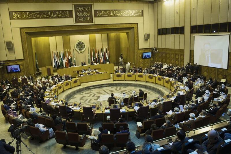 Arab foreign ministers take their seats for their meeting at the Arab League headquarters in Cairo on Sunday. Hassan Ammar / AP Photo