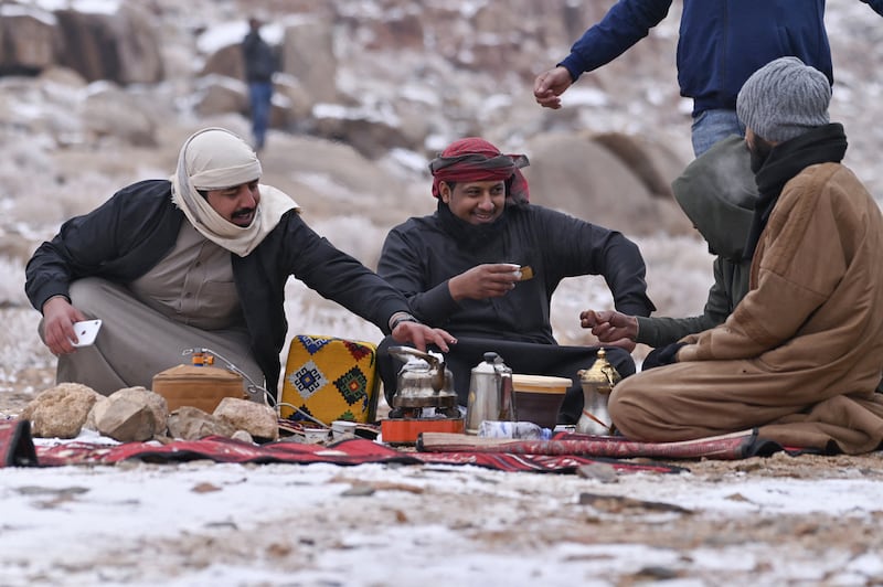 Visitors melt snow to make coffee at Jebel Al Lawz.