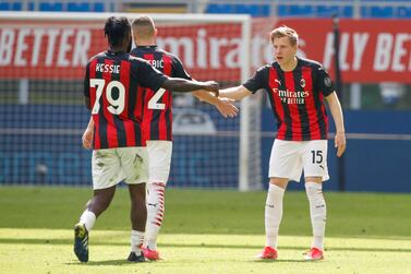 AC Milan's Jens Petter Hauge celebrates with his teammates after he scored his side's first goal during the Serie A soccer match between AC Milan and Sampdoria at the San Siro stadium, in Milan, Italy, Saturday, April 3, 2021. (AP Photo/Antonio Calanni)