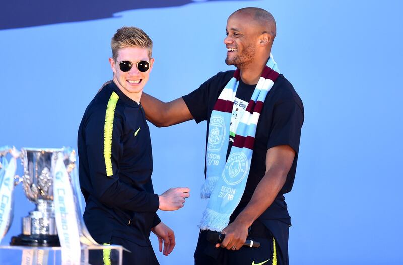 Kevin De Bruyne and Vincent Kompany of Manchester City celebrate on stage. Getty Images