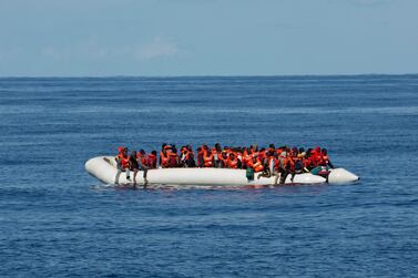 An aid group said gunmen on Libya-flagged speedboats threatened the crew of its rescue ship Alan Kurdi. AP