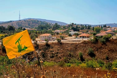 A Hezbollah flag flutters in the Khiyam plain on the Lebanese side of the border with Israel. Israel and Hezbollah exchanged fire on Sunday along the Lebanese border after a week of rising tensions, sparking fears of an escalation and prompting concern from world powers. AFP 