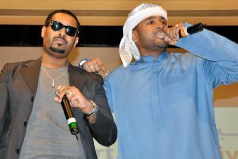 In the Kandoora is Abdullah Ali Dahman AKA Arab Leak and in the suit is Salim Ali Dahman AKA ILLMIYAH - The team are brothers that are the Hip Hop group Desert Heat.

Essam Al-Ghalib / The National