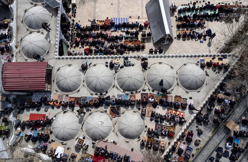 An aerial view of worshippers gathering for the first Friday prayers of Ramadan, outside the Ulu Grand Mosque in Kahramanmaras, southern Turkey. The mosque was damaged in February's earthquake, in which more than 50,000 people died in Turkey and Syria. EPA