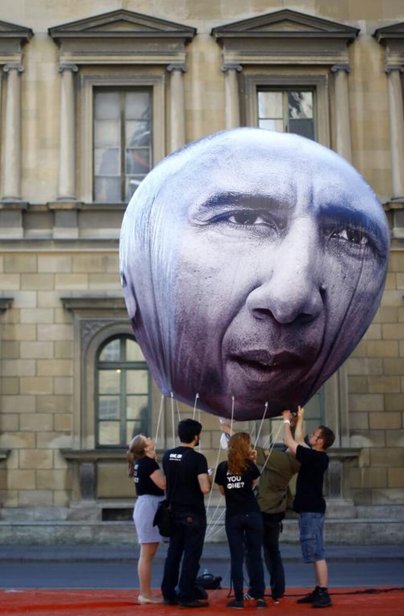 Activists from One, an international campaigning and advocacy organisation, prepare a balloon with the portrait of US president Barack Obama on it, during a protest against the upcoming G7 summit in Munich, Germany. Matthias Schrader/AP Photo