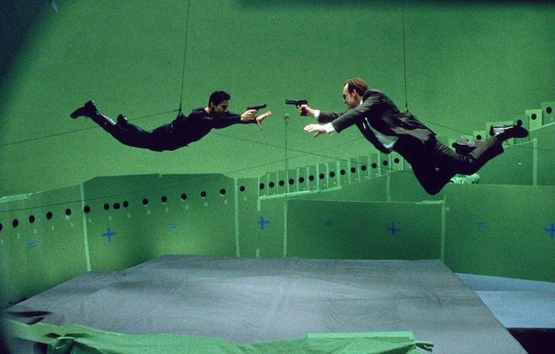 Keanu Reeves and Hugo Weaving on the set of The Matrix. Courtesy Warner Bros.