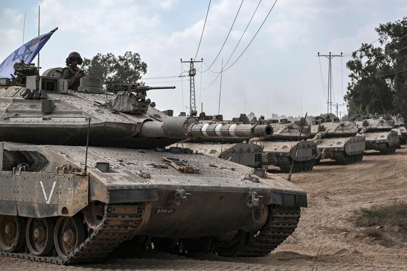 Israeli tanks stand along the border with Gaza in southern Israel, as battles between Israel and Hamas continue. AFP