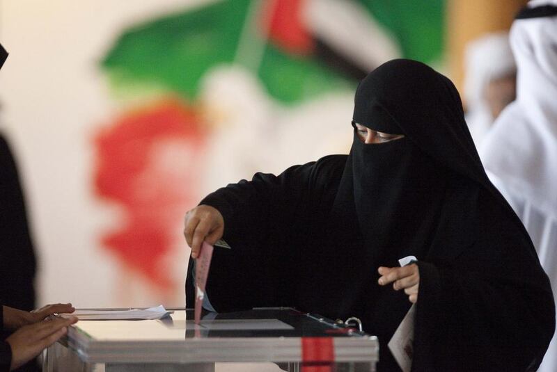An Emirati woman casts her vote in a box at the Ministry of Culture during the 2011 FNC elections. It is not clear how the introduction of the one vote per person will affect this year's election. Jaime Puebla / The National