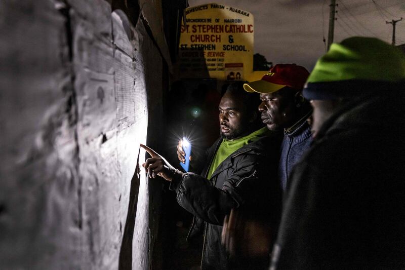 Voters check their names on an electoral roll in Nairobi. AFP