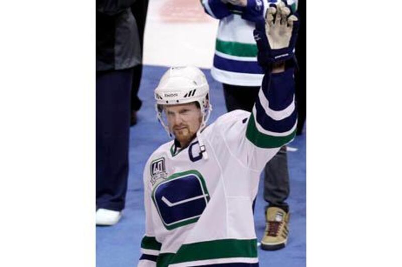 Vancouver Canucks center Henrik Sedin salutes the crowd after receiving his captain's jersey during a ceremony before their NHL game against the Los Angeles Kings in Vancouver, British Columbia October 9, 2010.    REUTERS/Lyle Stafford(CANADA - Tags: SPORT ICE HOCKEY)