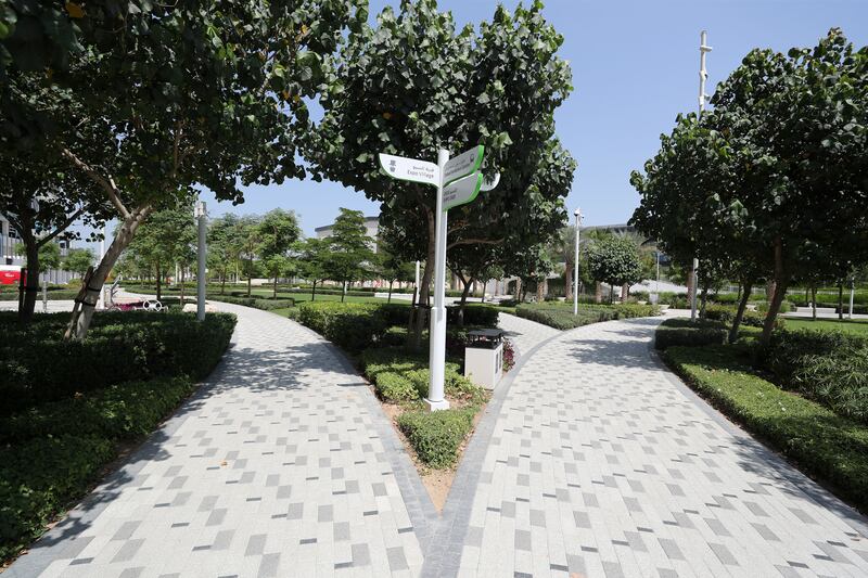 Tree-shaded walkways at Expo Village. Developers describe it as 'a village within a village'.