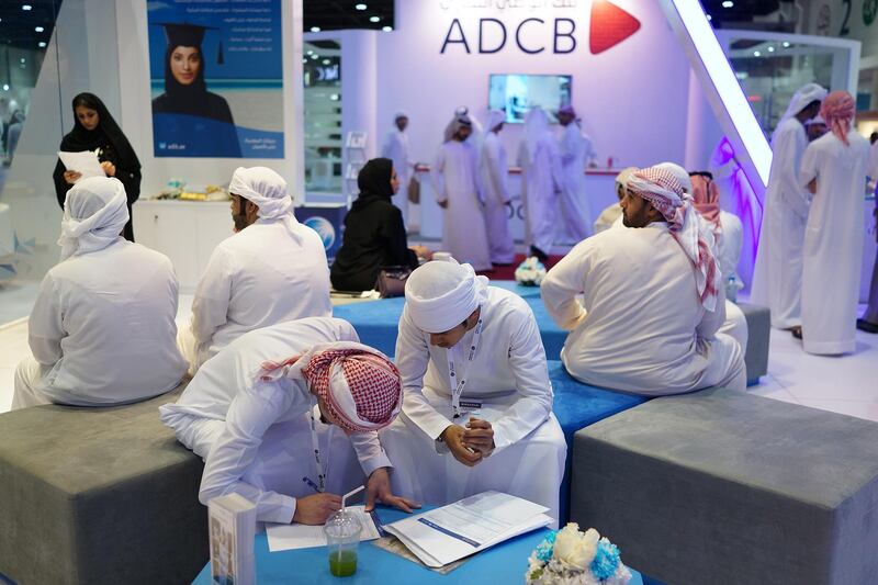 ABU DHABI, UNITED ARAB EMIRATES - - -  30 January 2017 --- UAE Nationals complete job application forms while waiting for an on-site interview at the ADCB exhibit during the first day of Tawdheef, a career recruitment event for UAE Nationals, on Monday, January 30, 2017, at ADNEC in Abu Dhabi.   (  DELORES JOHNSON / The National  )  
ID: none
Reporter:  None
Section: NA *** Local Caption ***  DJ-300117-NA-TAWDHEEF standalone-009.jpg