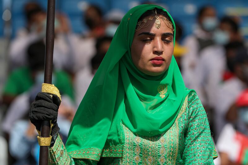 A woman holds a flag at the opening ceremony. Oman beat Papua New Guinea by 10 wickets with 38 balls remaining in the first match of the Twenty20 World Cup. AP