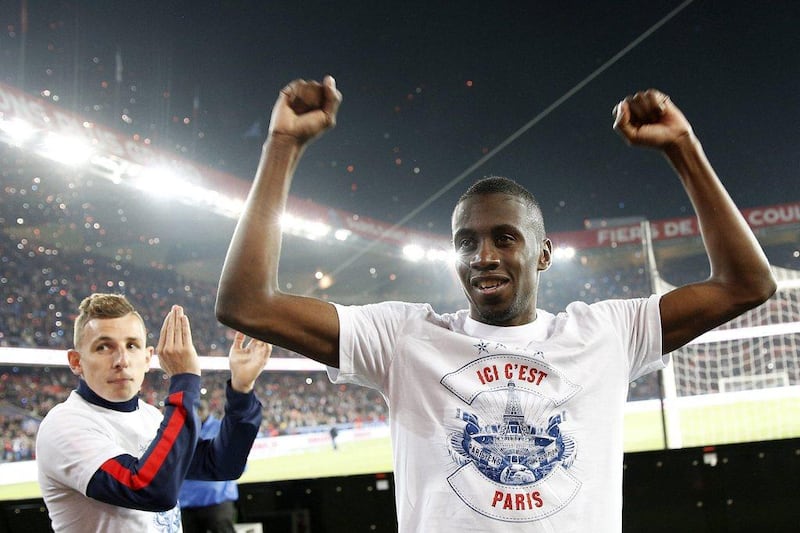 Blaise Matuidi, right, and Lucas Digne, left, of Paris Saint-Germain celebrate the Ligue 1 title after their match against Rennes on Wednesday. Yoan Valat / EPA / May 7, 2014