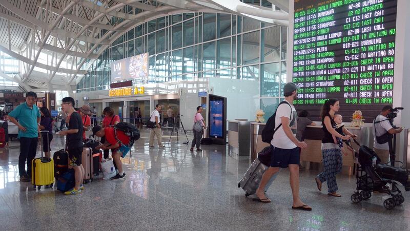 Passengers wait for their flight scheduled at Bali's Ngurah Rai International Airport in Bali. Wira Surya / EPA