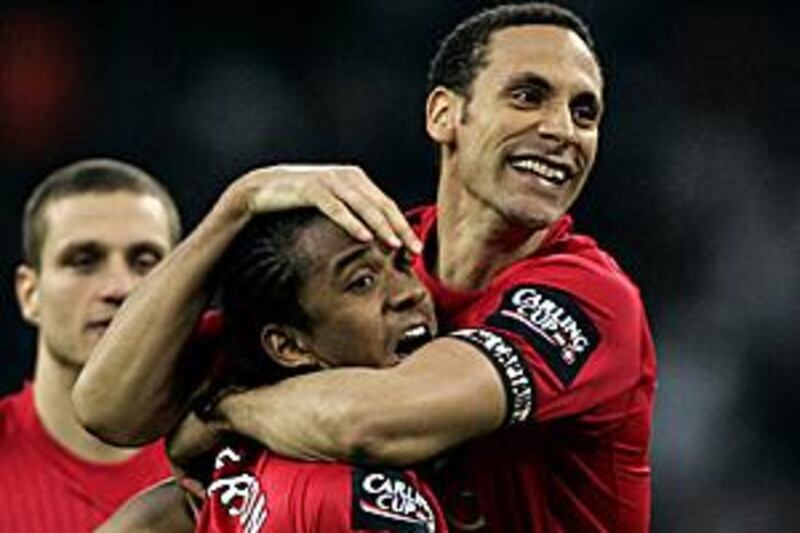 The Manchester United midfielder Anderson, left, is hugged by his captain Rio Ferdinand after the Brazilian scores the winning penalty in the final of the Carling Cup.